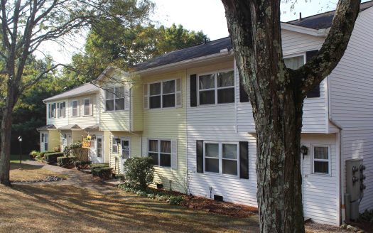 White and yellow siding on attached condominium units in Danbury, Connecticut